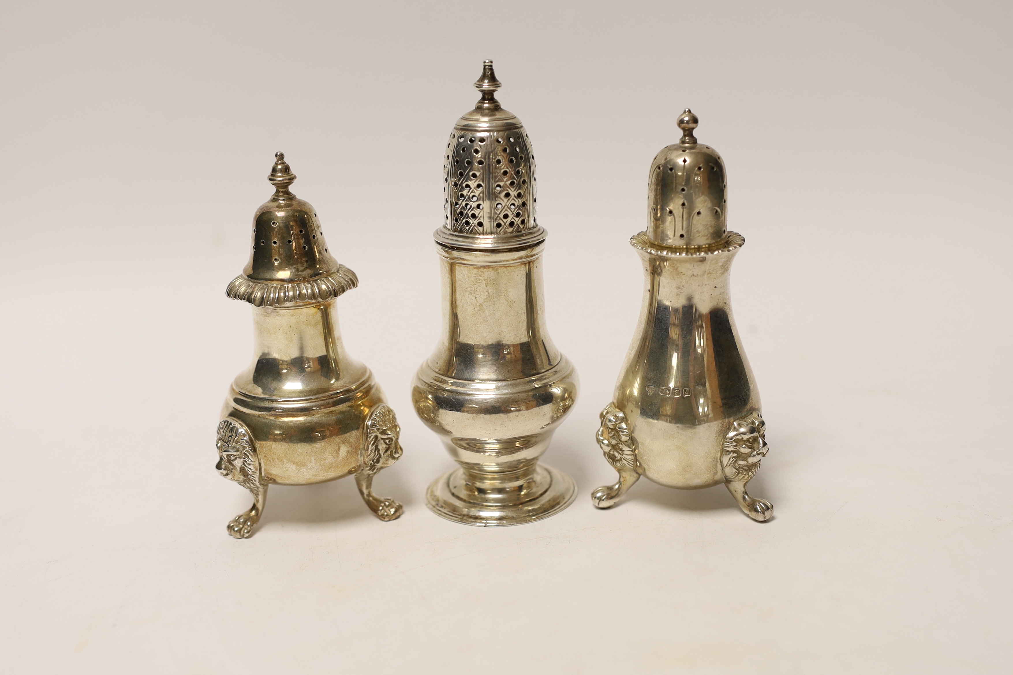 A George III silver baluster pepperette, London, 1763, 12.7cm, together with two modern silver pepperettes.